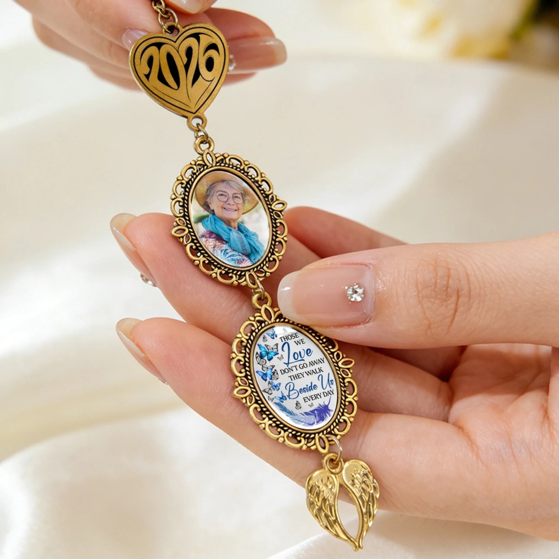 Custom graduation memorial charm featuring photo frame and angel wing pendant