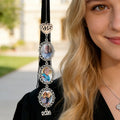Graduate wearing personalized memorial tassel photo charm during graduation ceremony