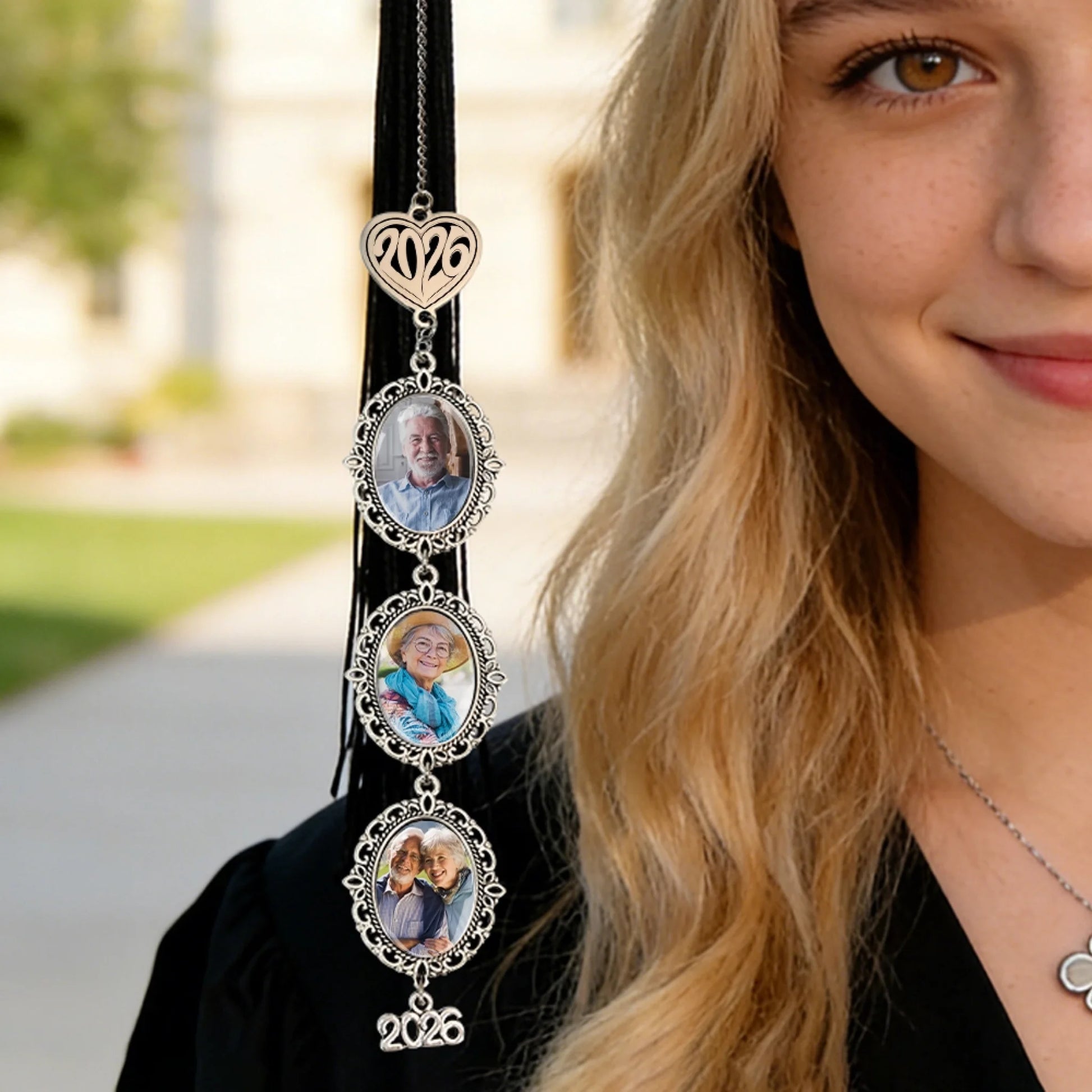 Graduate wearing personalized memorial tassel photo charm during graduation ceremony