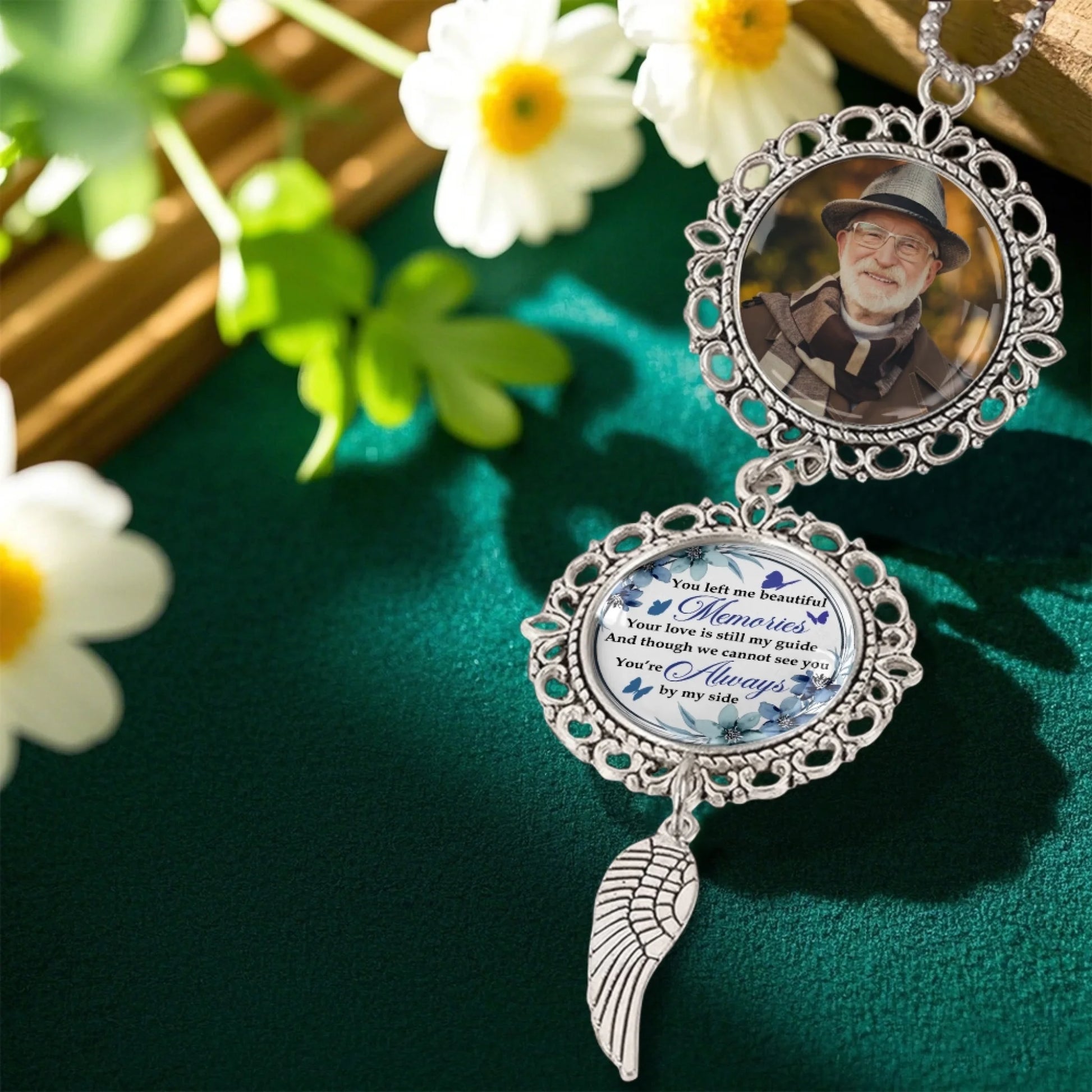 Custom remembrance car charm displayed in a memorial floral setting