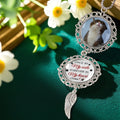Personalized memorial ornament hanging in decorative floral setting
