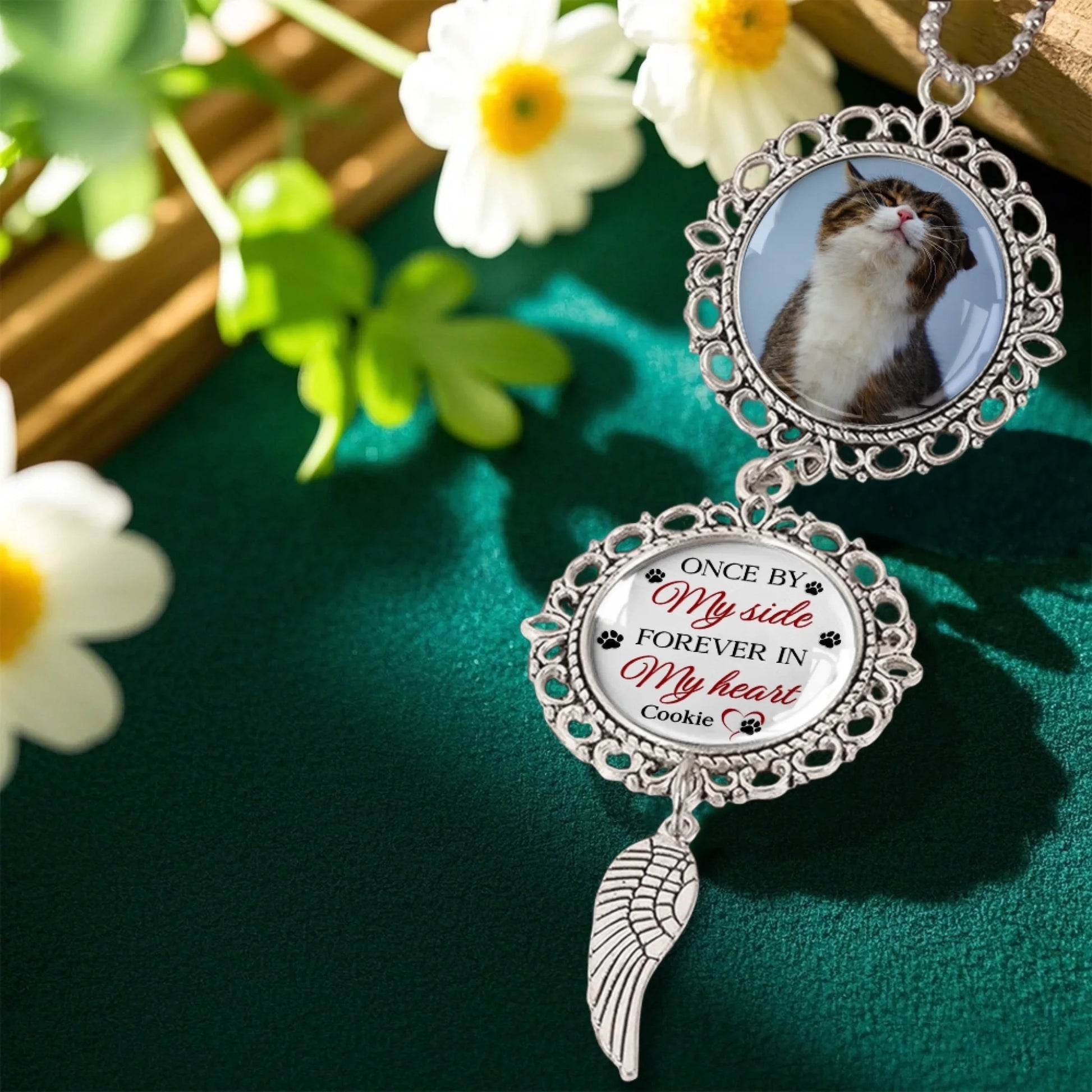 Personalized memorial ornament hanging in decorative floral setting
