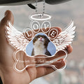Custom pet remembrance ornament displayed in hand with angel wings design
