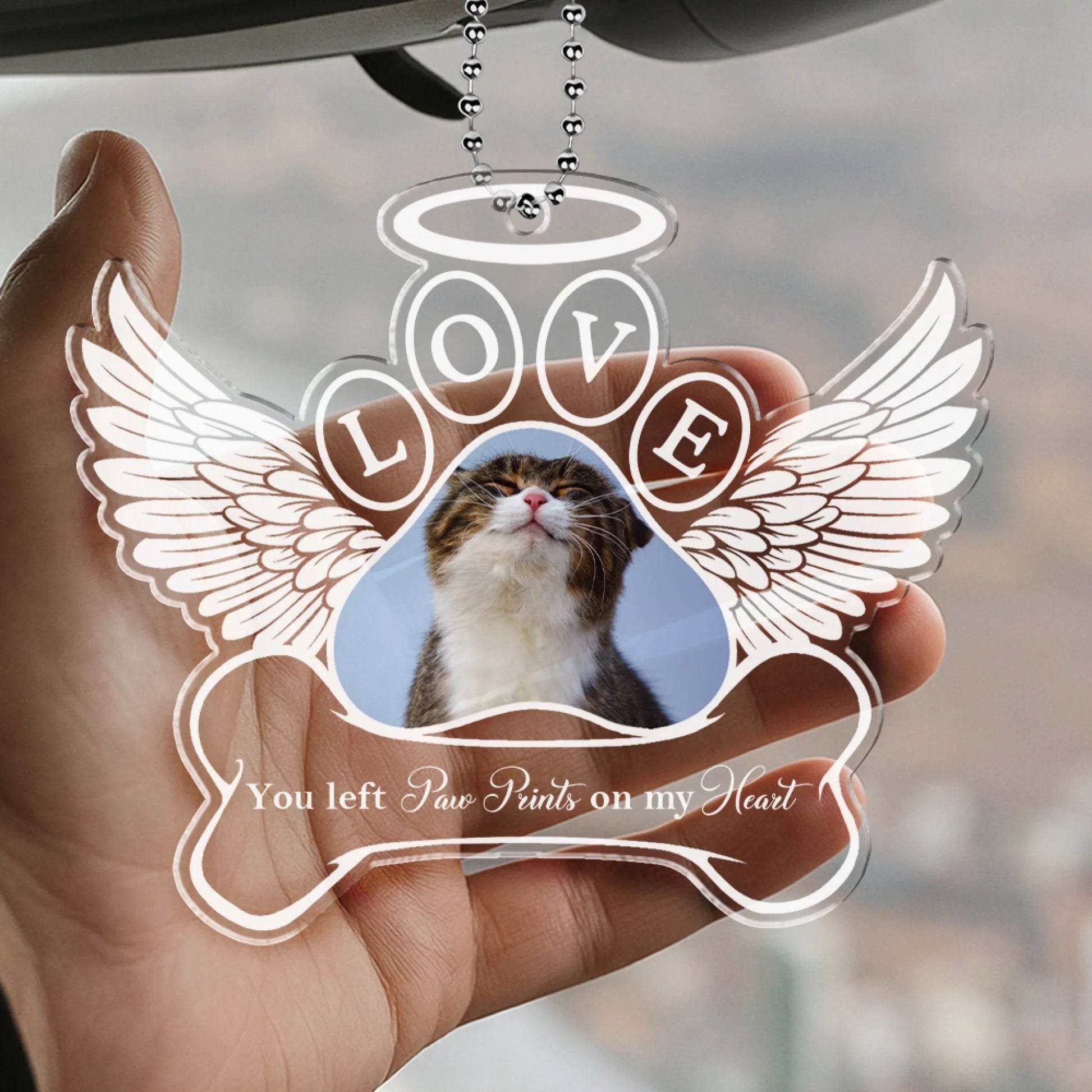 Custom pet remembrance ornament displayed in hand with angel wings design
