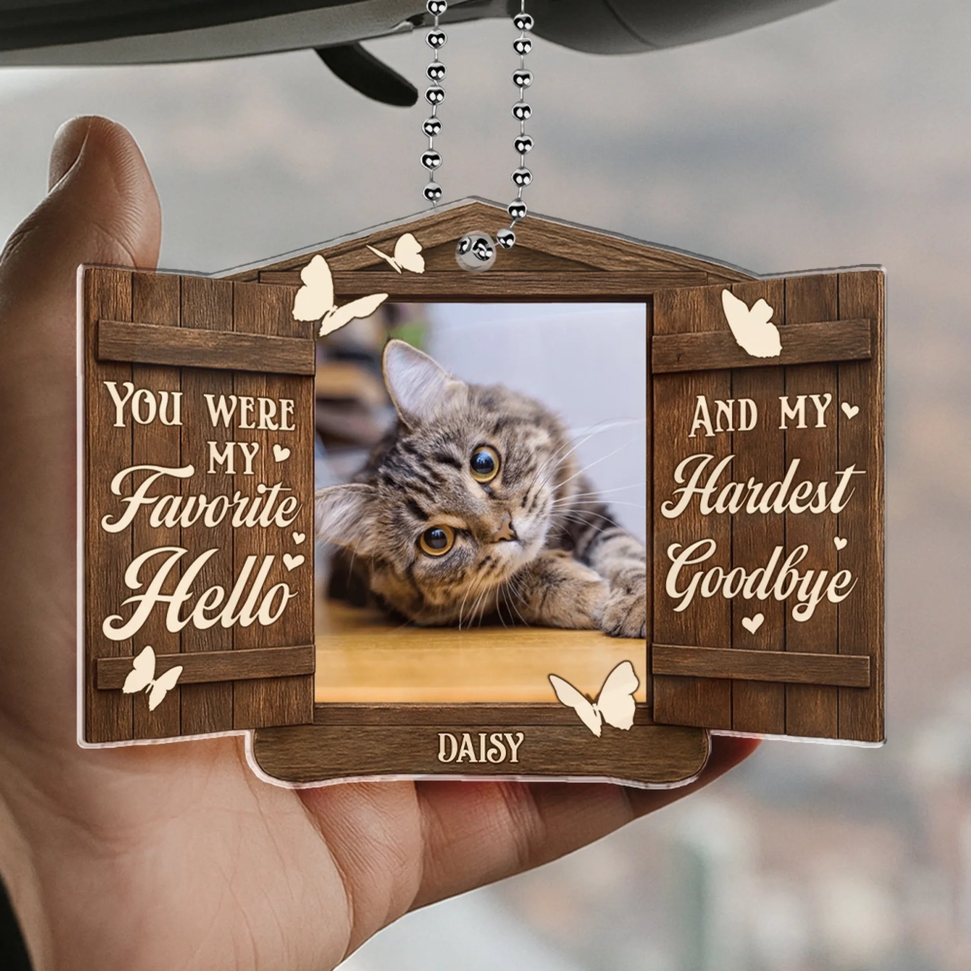 Custom pet remembrance ornament displayed in hand with personalized photo