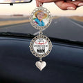 Memorial photo ornament hanging from rearview mirror inside a car