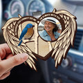 Memorial car visor clip with angel wings displayed inside vehicle