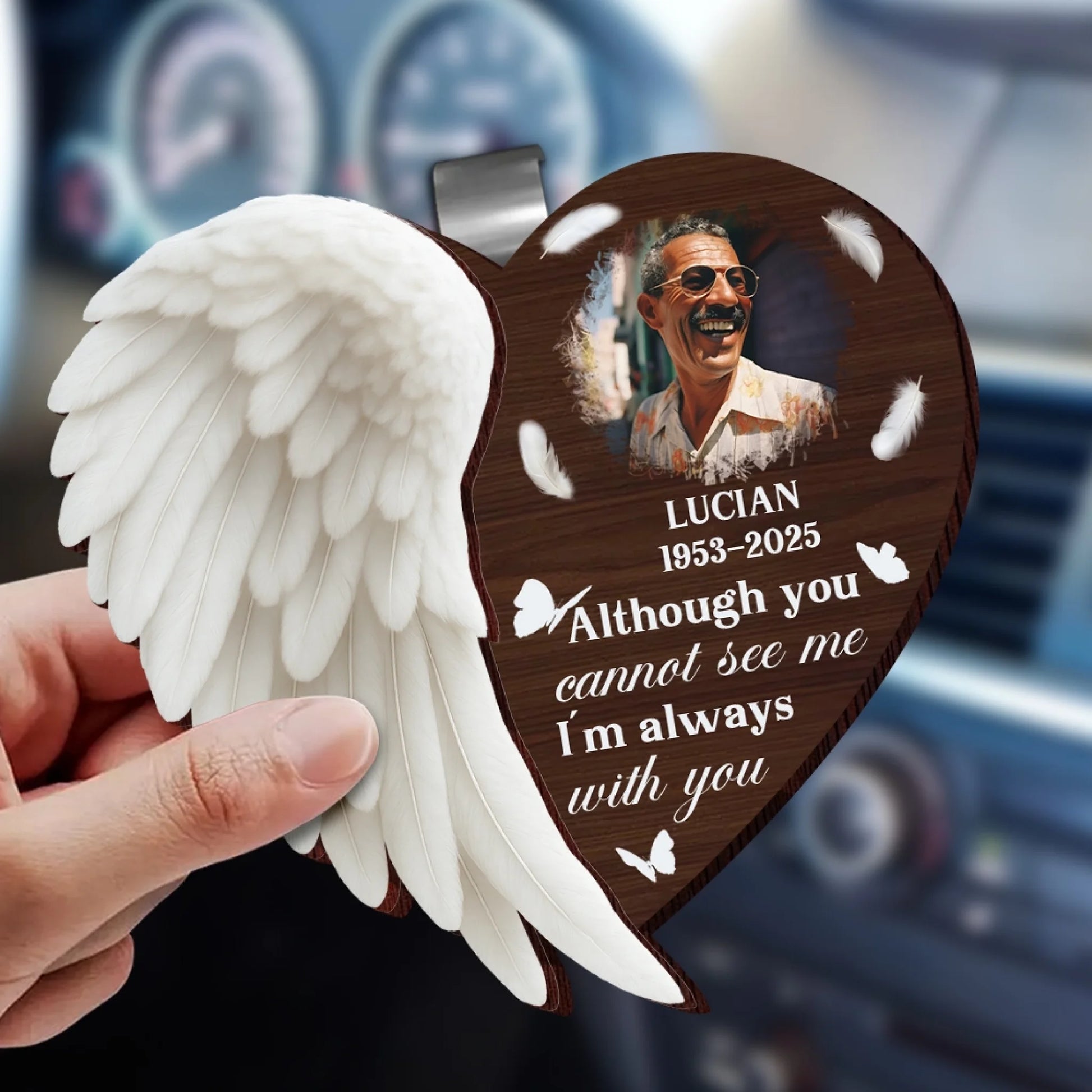 Wooden angel wing memorial visor clip displayed inside vehicle