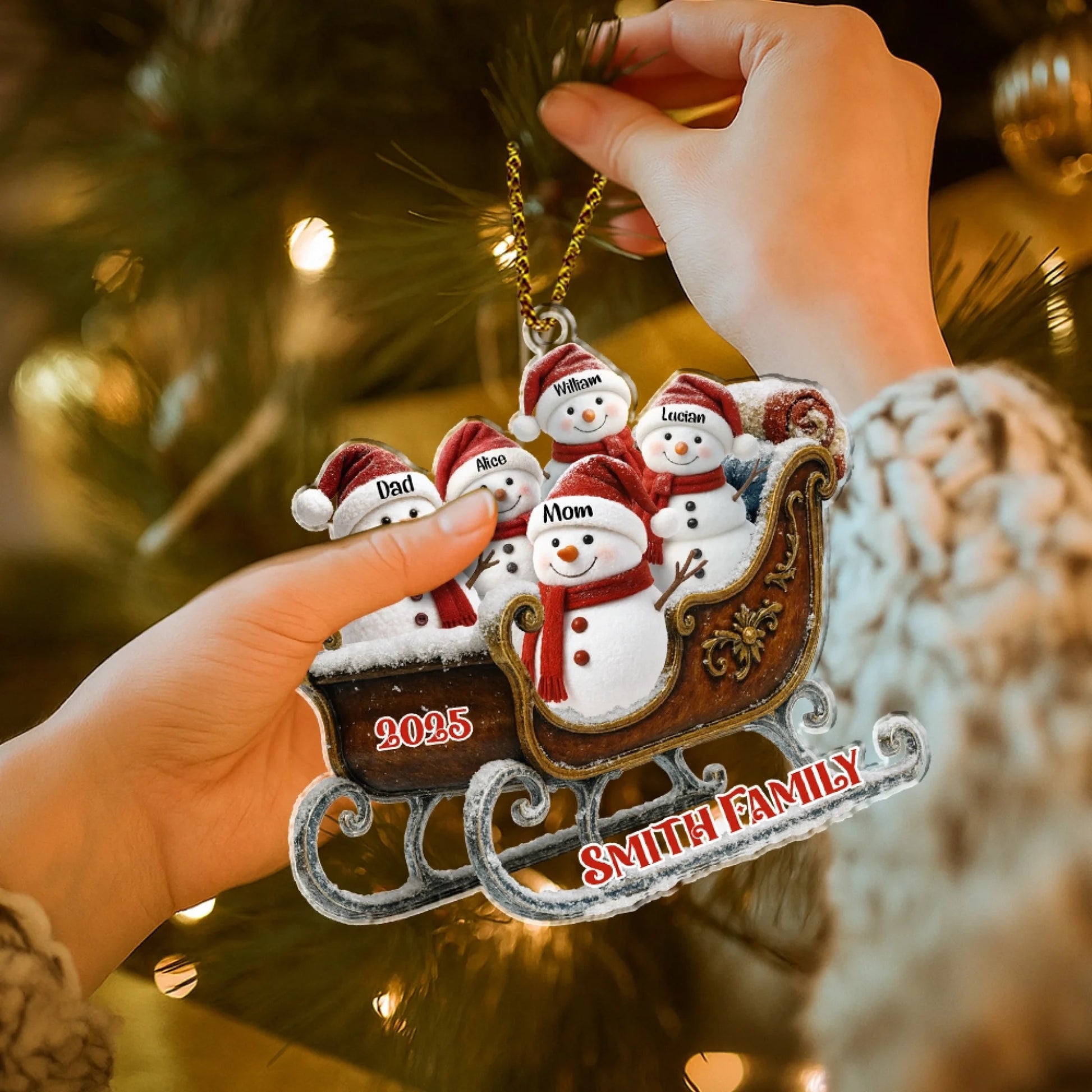 Custom snowman family Christmas ornament hanging on tree