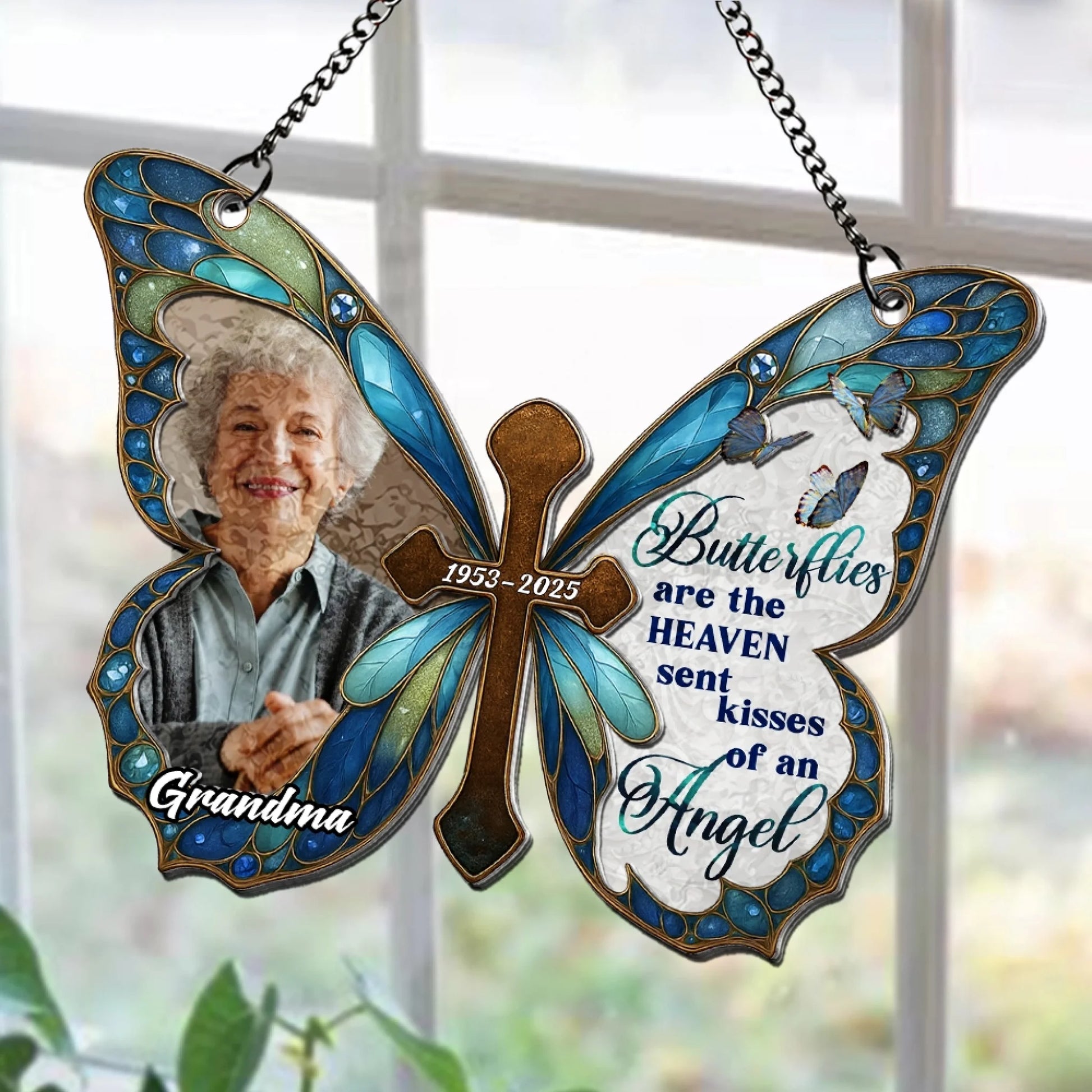 Personalized butterfly cross remembrance suncatcher displayed in window