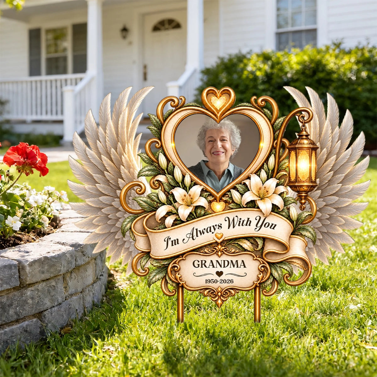Angel wings memorial garden stake with grandma photo on a front lawn