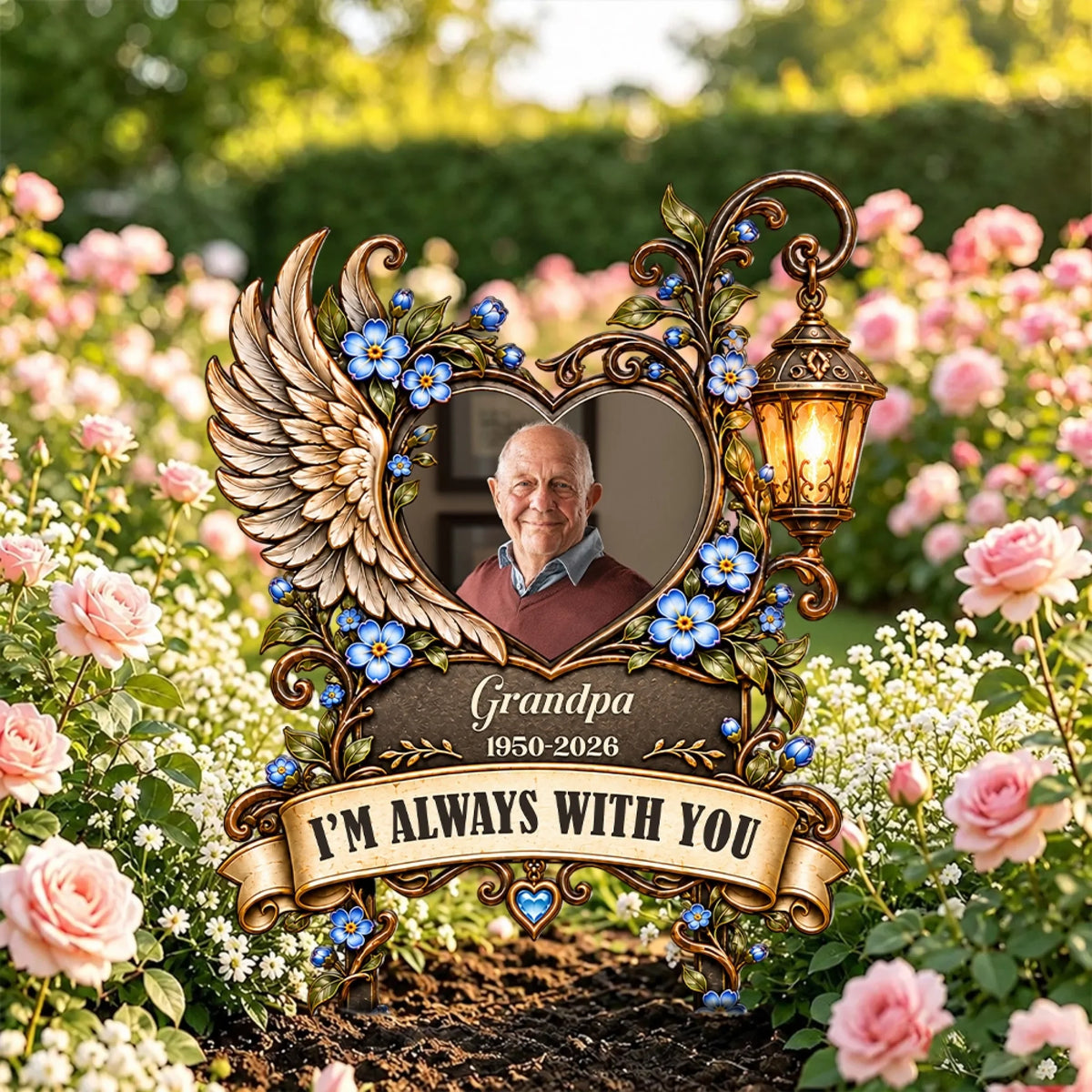 Memorial garden stake with photo and forget-me-nots standing among pink roses