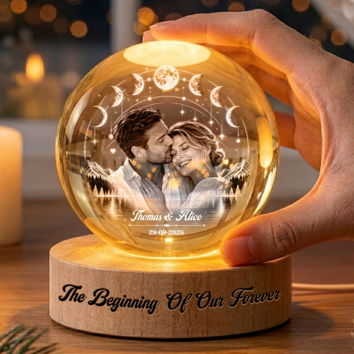 Hand holding a personalized crystal globe lamp with couple photo and moon arc