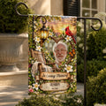 Memorial garden flag with grandpa photo on a metal stand beside a stone planter