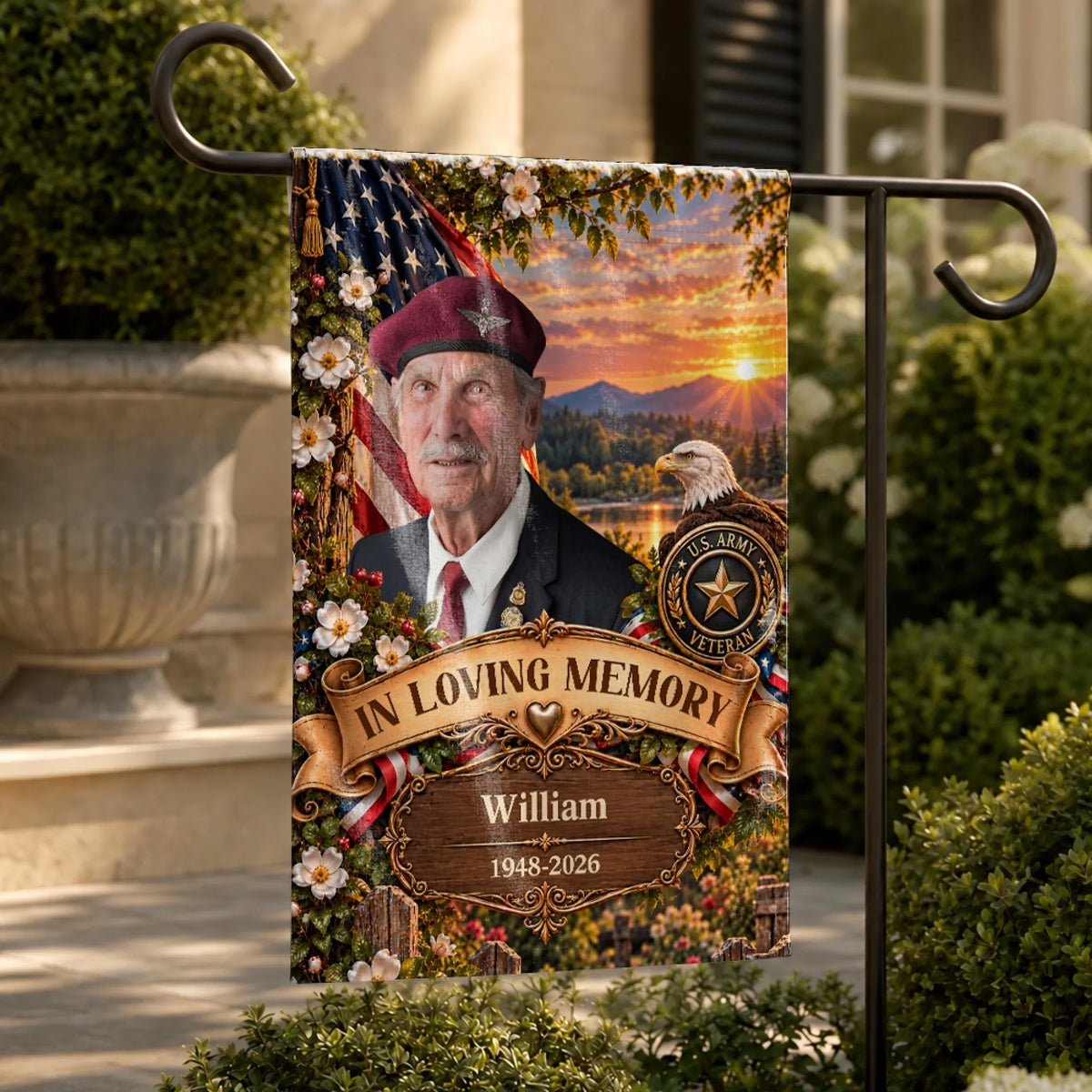 Veteran memorial garden flag with photo on a metal stand beside a stone planter