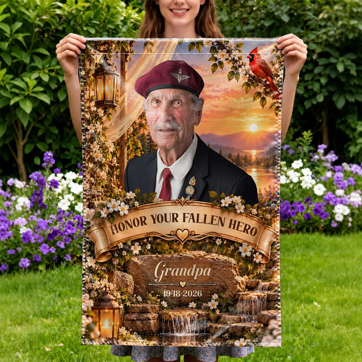 Woman holding a memorial garden flag with grandpa photo in a flower garden