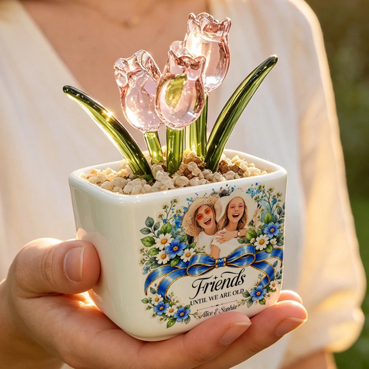 Hand holding personalized pink glass tulip pot with best friends photo