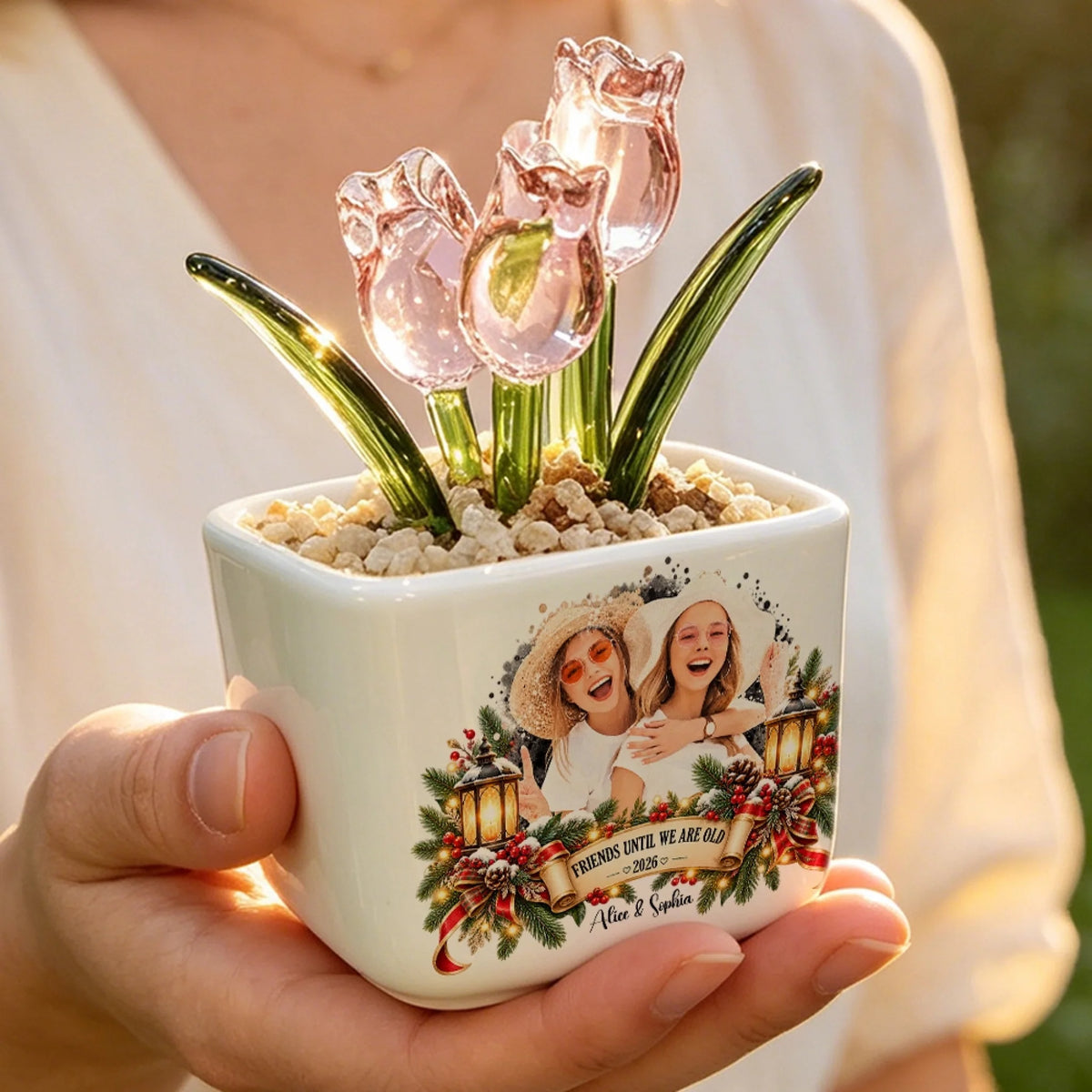 Hand holding personalized pink glass tulip pot with Christmas lantern design