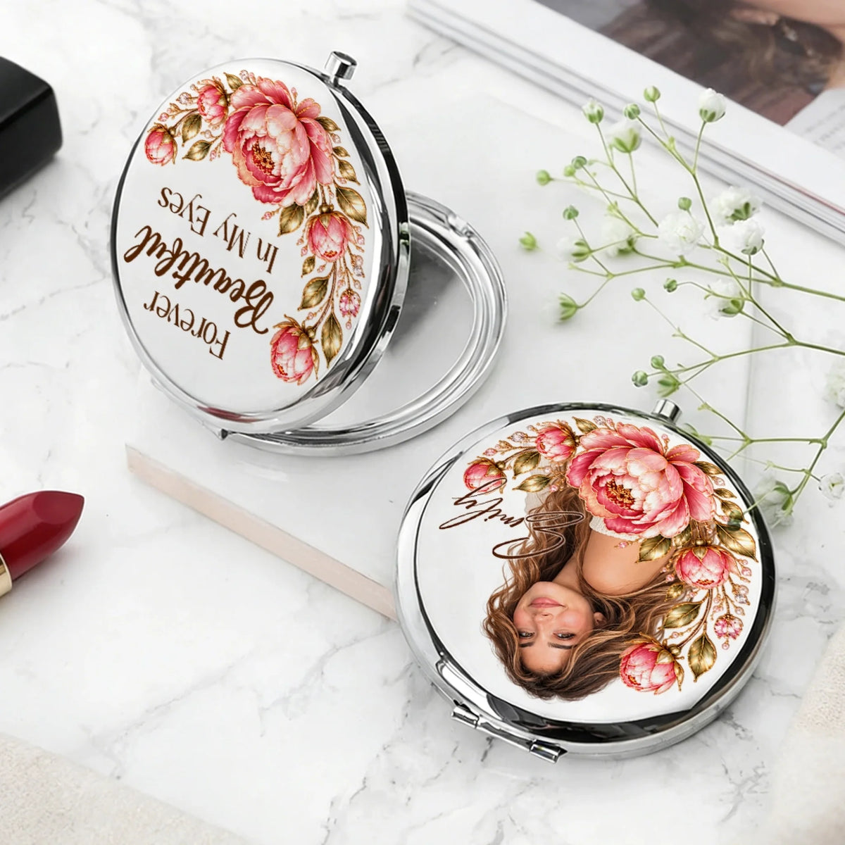 Silver personalized compact mirror with Forever Beautiful quote beside lipstick and flowers