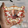 Hand holding red butterfly memorial car hanger with grandpa photo and family quote