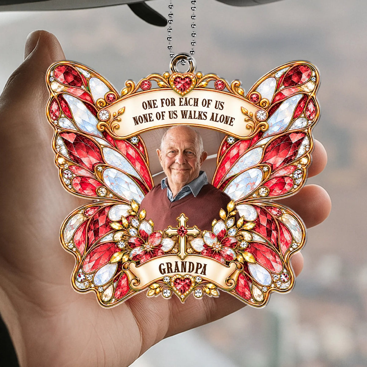 Hand holding red butterfly cross car hanger with grandpa photo and family quote