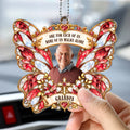 Red butterfly memorial car hanger with gold cross and photo hanging in car