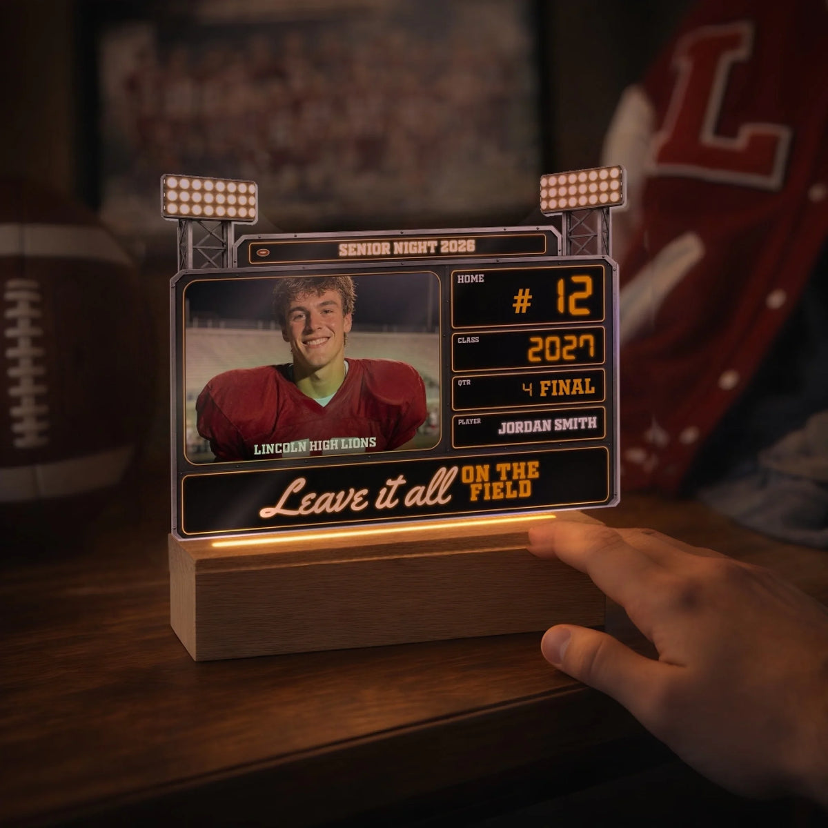 Scoreboard LED lamp glowing on a shelf next to a football
