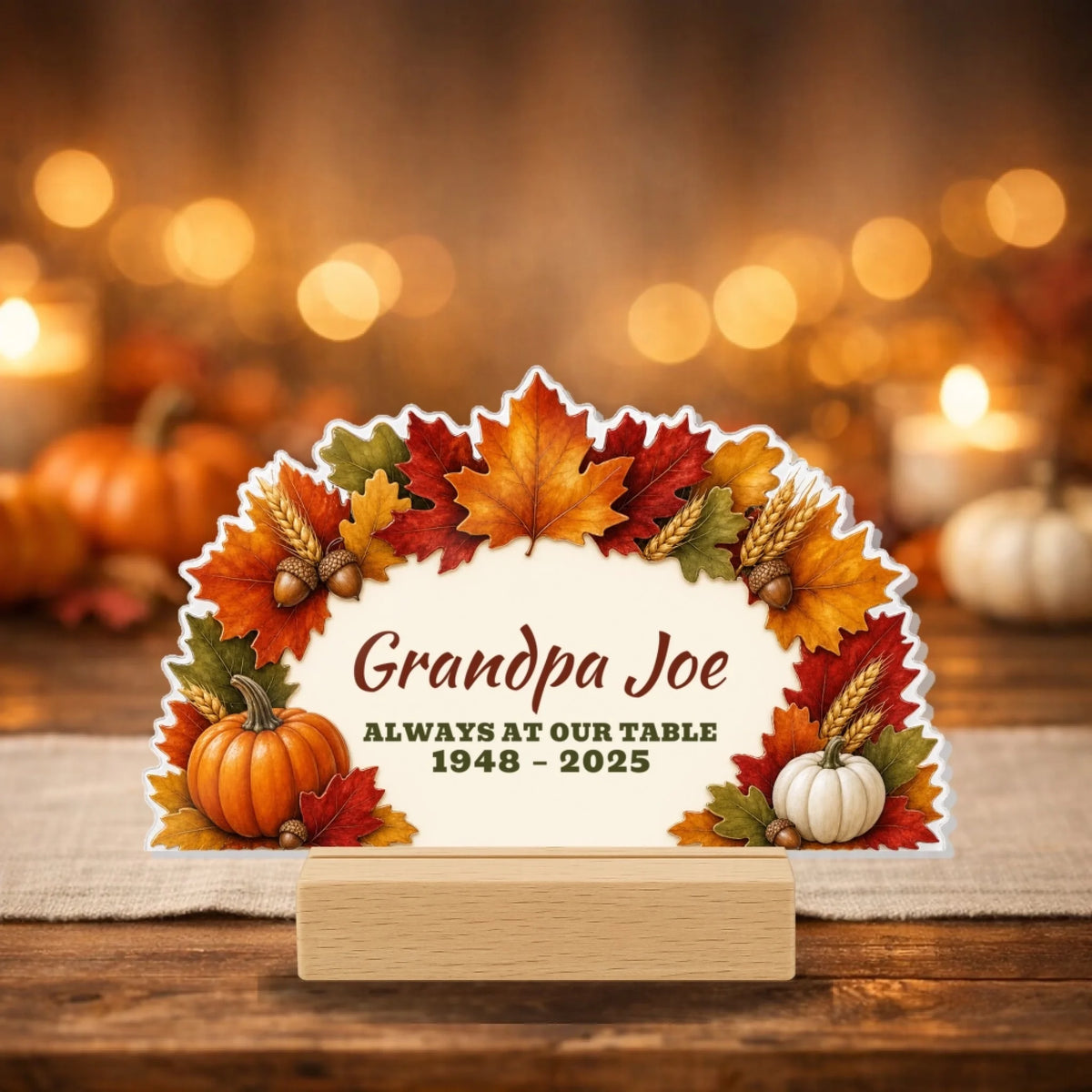 Autumn leaves and pumpkins memorial sign reading Always At Our Table