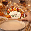 Thanksgiving memorial sign set beside a dinner plate on a holiday table