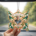 Hand holding green butterfly memorial car hanger with photo inside a car