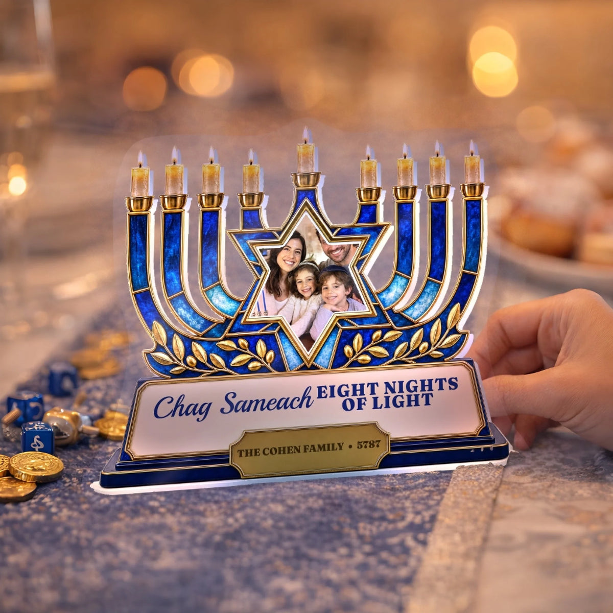 Hanukkah menorah photo plaque standing on a table with dreidels and gelt
