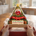 Hands lifting a grandparents Christmas night light from a gift box