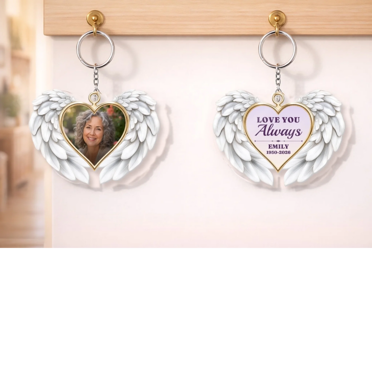 Memorial photo keychains with angel wings hanging on a wall hook
