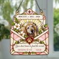 Stained glass style pet memorial suncatcher hanging in a sunny window