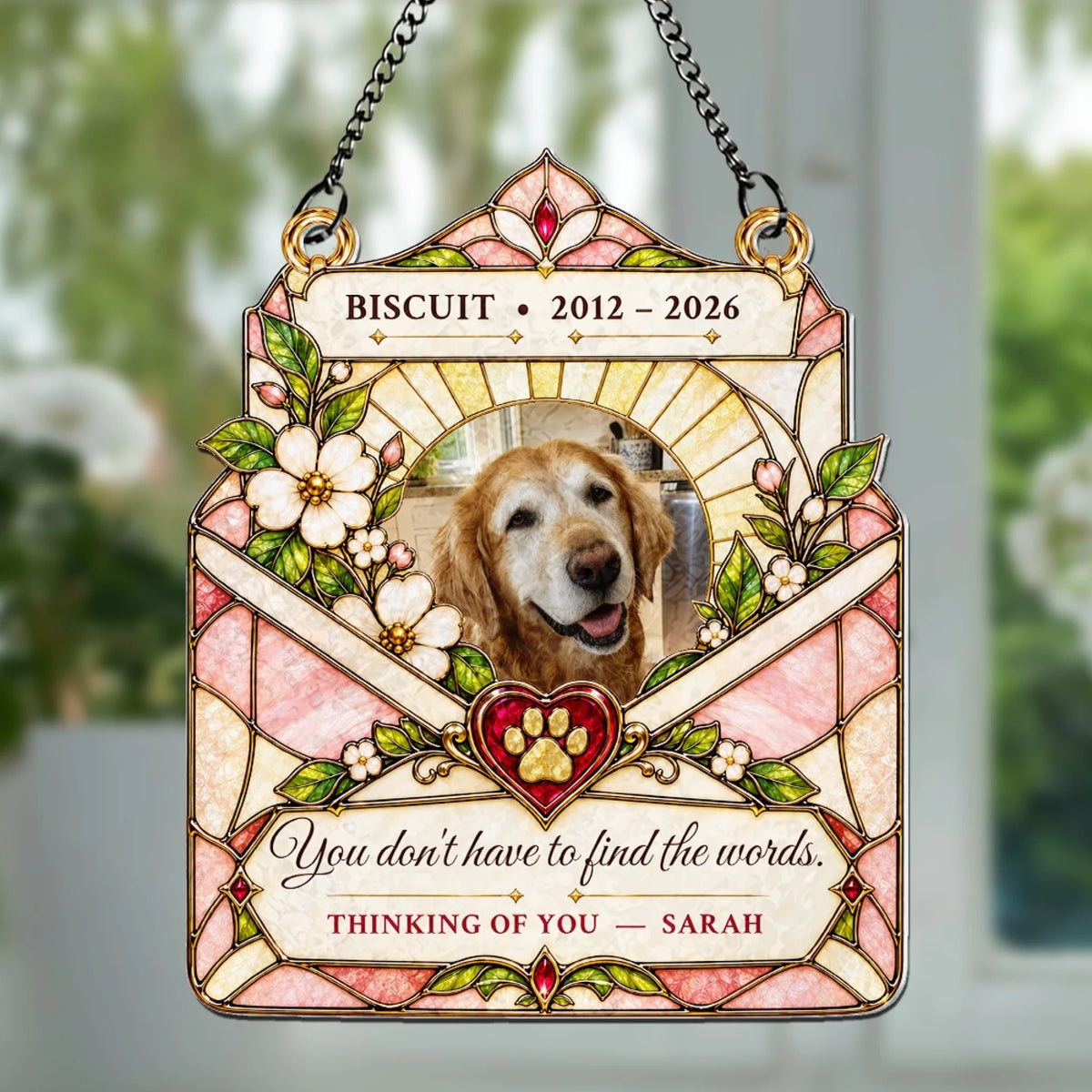 Stained glass style pet memorial suncatcher hanging in a sunny window