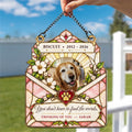 Hand holding a pink envelope pet sympathy suncatcher outdoors