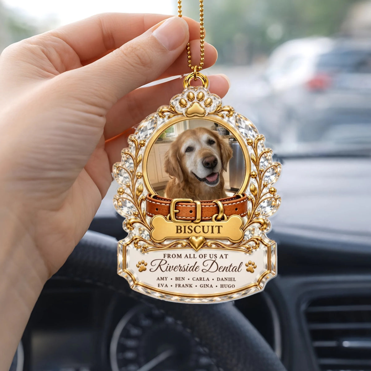 Hand holding a pet memorial car hanger with workplace and coworker names