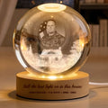 Veteran memorial crystal globe lamp with photo above a snowy home