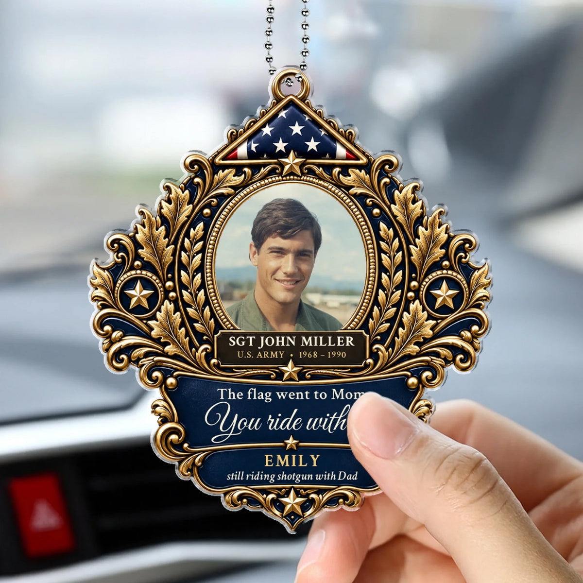 Hand holding a folded flag memorial car hanger inside a car