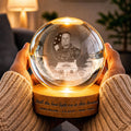 Hands holding a veteran photo globe lamp glowing warm at night