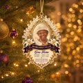 Gold sunburst memorial photo ornament hanging on a lit Christmas tree