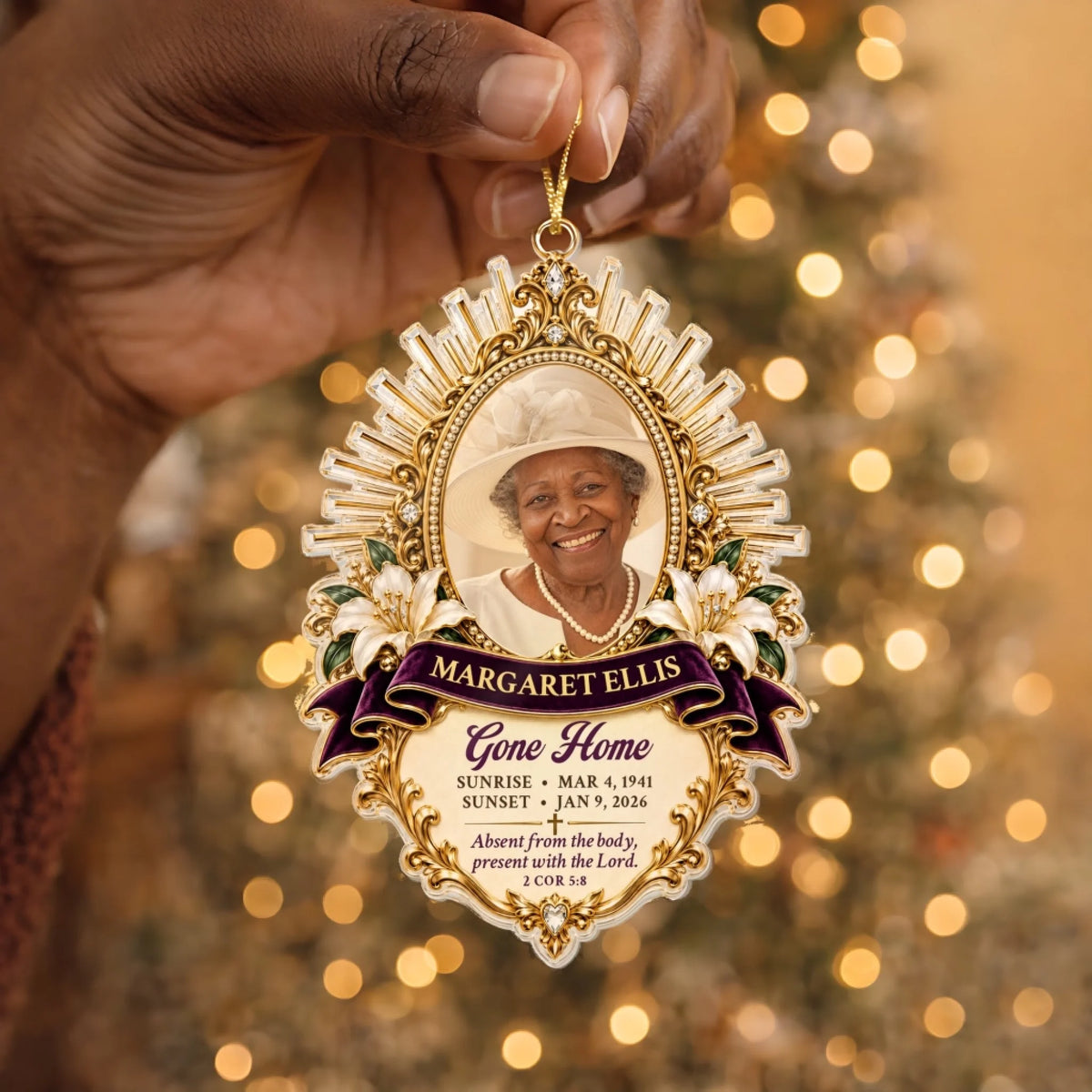Hand holding a homegoing memorial ornament with name and sunrise sunset dates