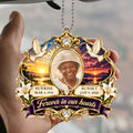 Hand holding a sunrise sunset memorial car hanger with doves and lilies
