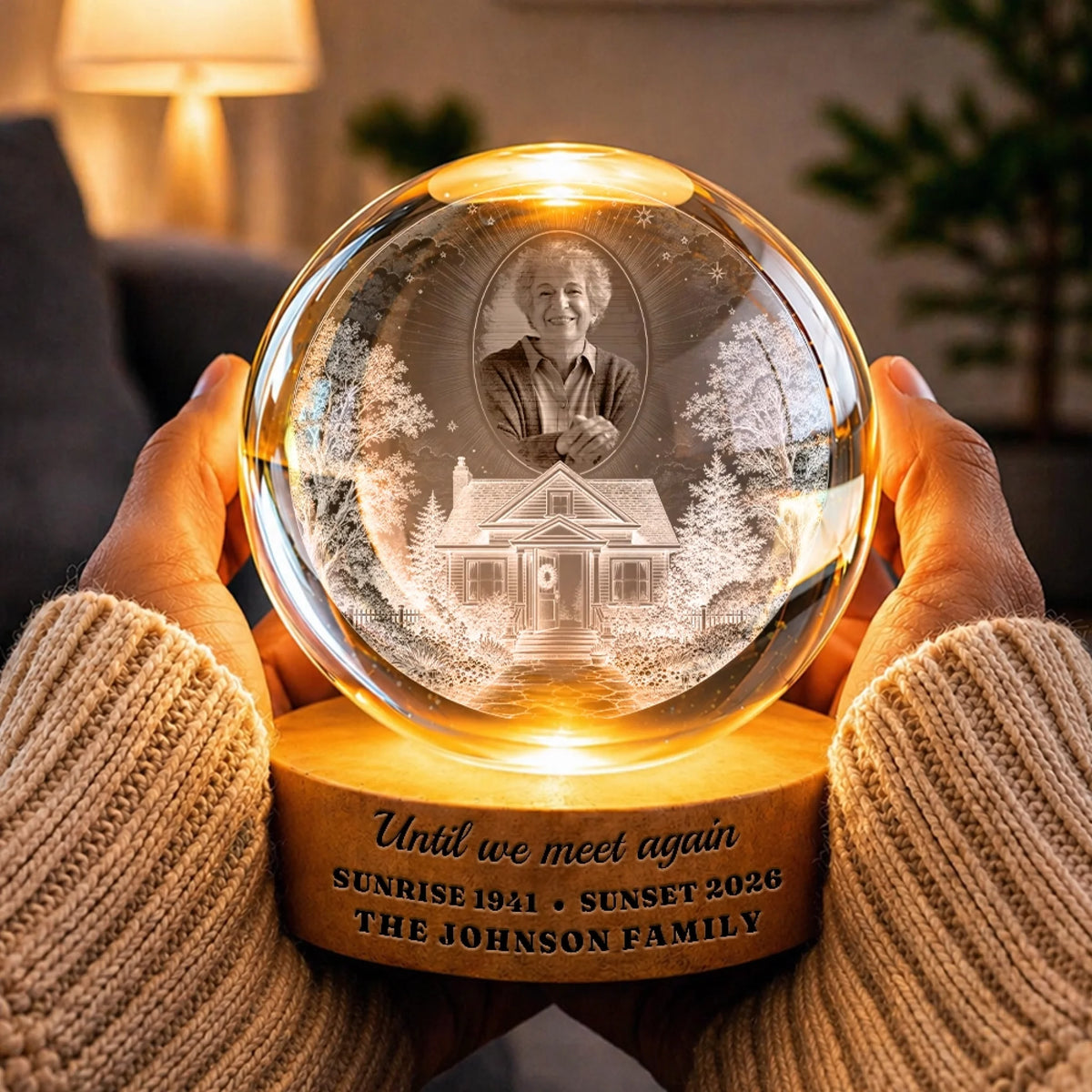 Hands holding a memorial photo globe lamp with path to home glowing warm