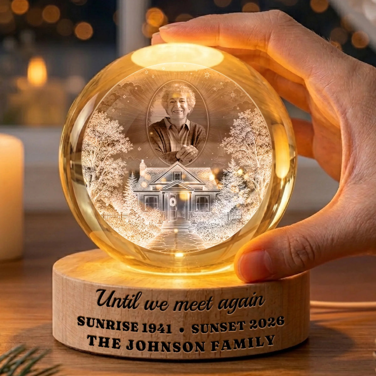 Hand holding a glowing homegoing globe lamp with family name on the base