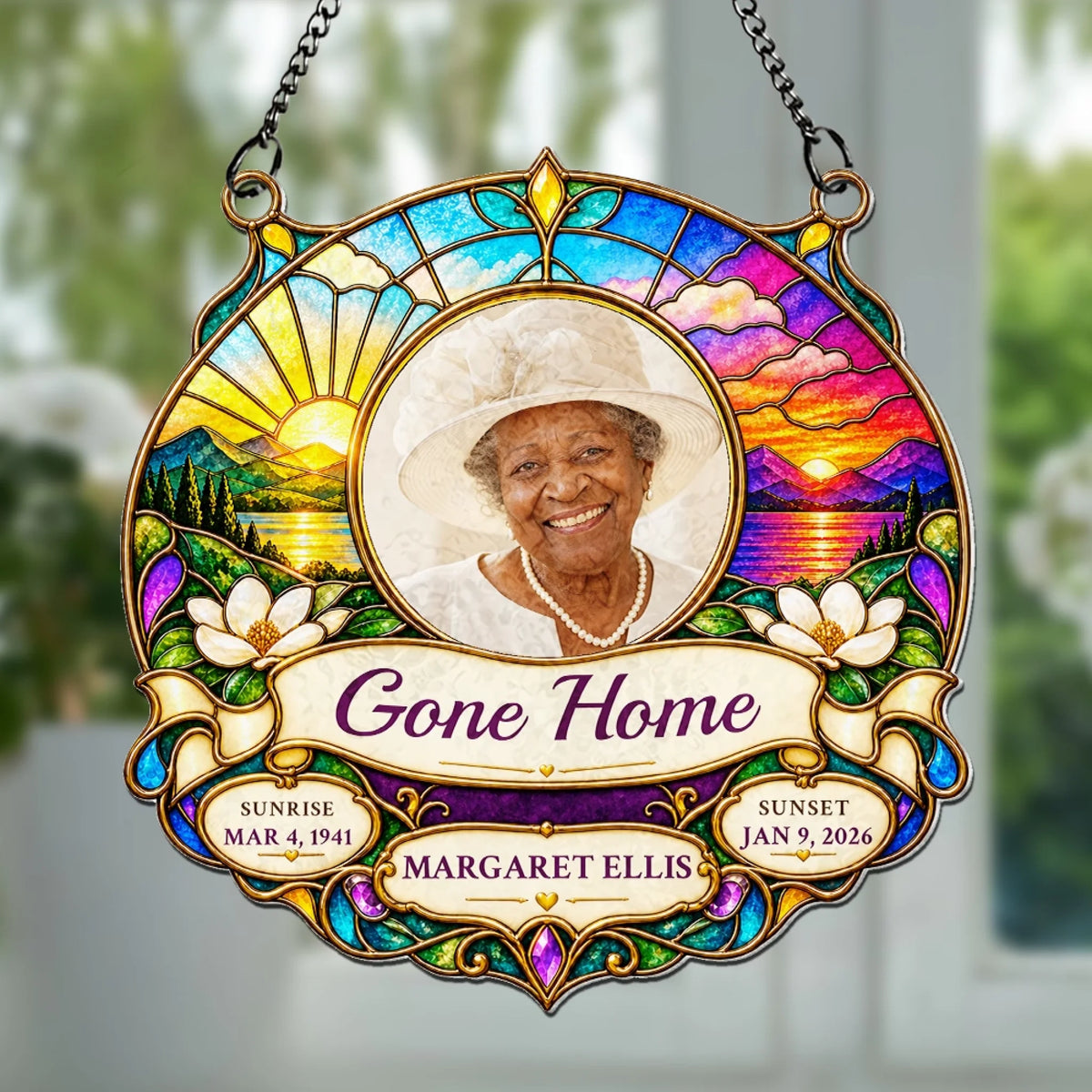 Gone Home memorial suncatcher with photo hanging in a garden window
