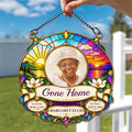 Hand holding a stained glass style homegoing suncatcher outdoors
