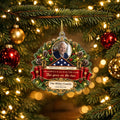 Veteran memorial Christmas ornament with photo, folded flag and quote ribbon on a tree