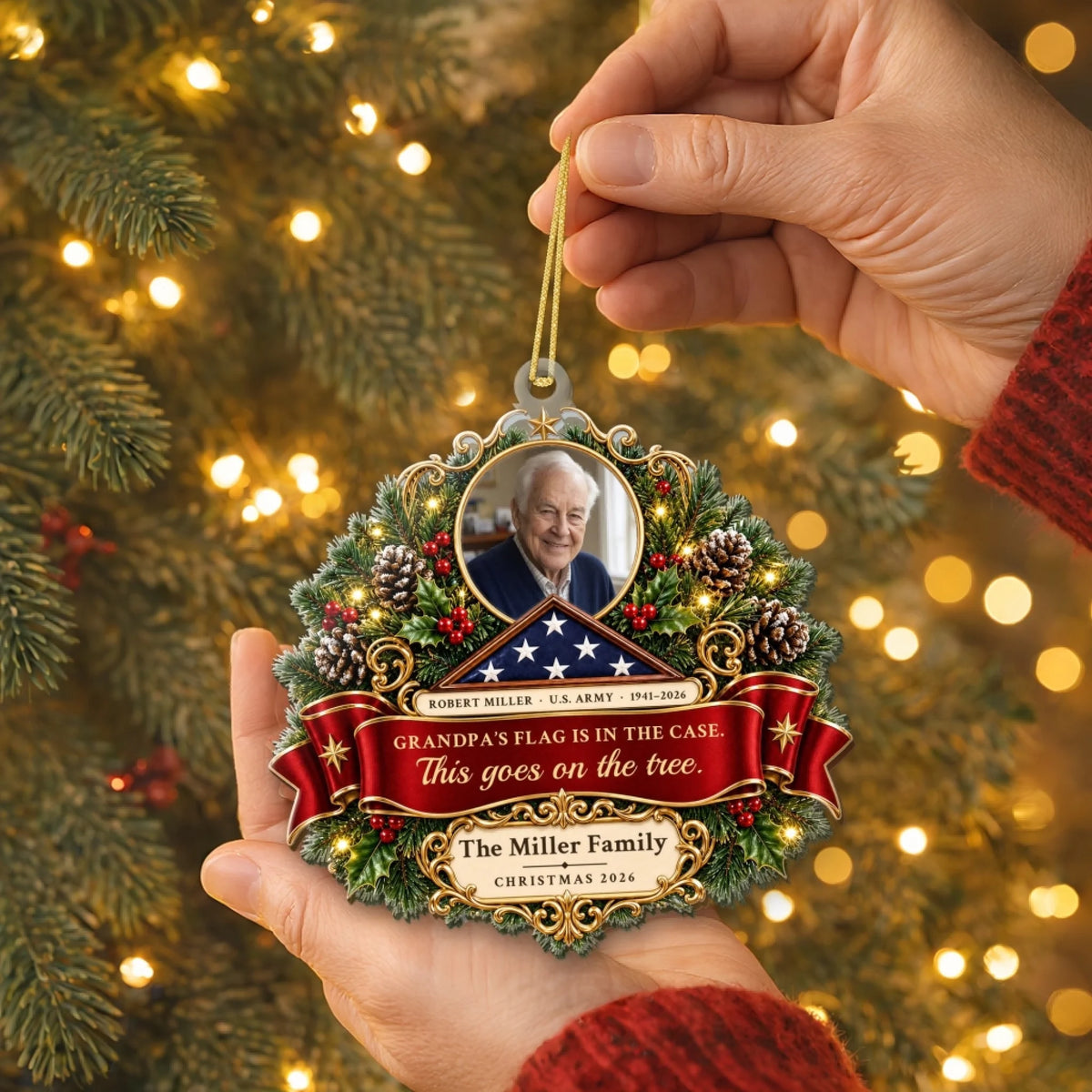 Hand holding the veteran memorial ornament with family name plate against pine branches