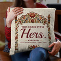 Woman holding empty chair memorial pillow with This Chair Stays Hers quote